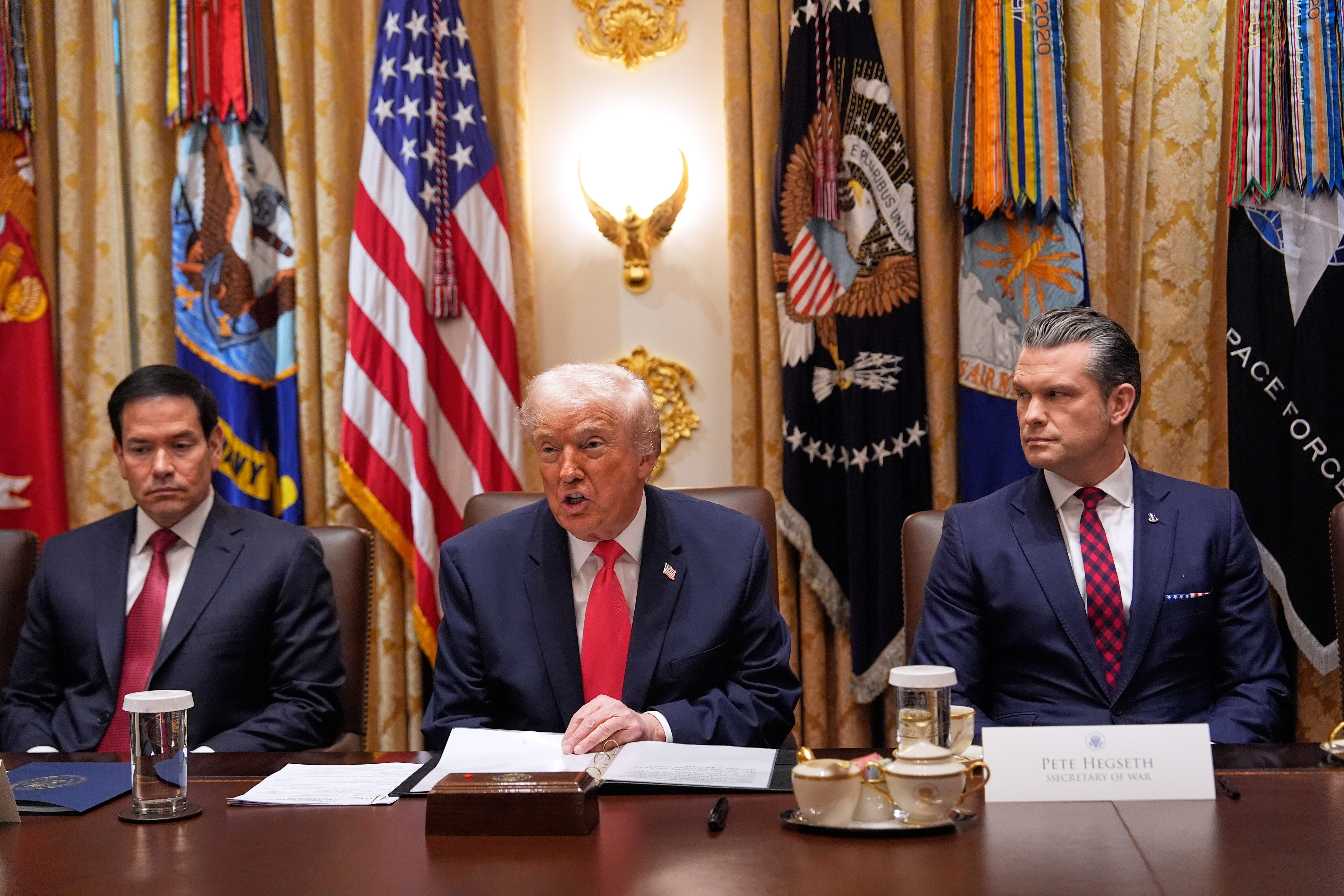 President Trump speaks during a Cabinet meeting at the White House, Tuesday, as Secretary of State Marco Rubio (left) and Defense Secretary Pete Hegseth look on.